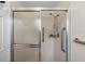 Shower features frosted glass doors, a handheld shower head, and safety bars at 1020 Lake Avoca Dr, Tarpon Springs, FL 34689
