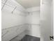 The main bedroom features a walk-in closet fitted with wire shelving at 1020 Lake Avoca Dr, Tarpon Springs, FL 34689