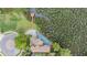 Aerial view of a home with a triangular screened-in pool and a private dock at 104 Westbrook Ct, Safety Harbor, FL 34695