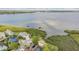 Gorgeous waterfront home with lush mangroves and a private dock on a sunny day at 104 Westbrook Ct, Safety Harbor, FL 34695