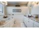 Bathroom featuring granite countertops, soaking tub, chandelier, and modern finishes at 104 Westbrook Ct, Safety Harbor, FL 34695