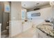 Elegant bathroom with a soaking tub, granite countertops, and a chandelier at 104 Westbrook Ct, Safety Harbor, FL 34695