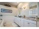 Well-appointed bathroom featuring granite countertops and decorative wainscoting at 104 Westbrook Ct, Safety Harbor, FL 34695