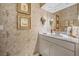 Bathroom featuring sink and vanity, patterned wallpaper, and overhead vanity lighting at 104 Westbrook Ct, Safety Harbor, FL 34695