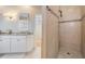 Elegant bathroom with granite countertops, white cabinetry, and tiled walk-in shower at 104 Westbrook Ct, Safety Harbor, FL 34695