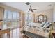 Sunlit bedroom featuring hardwood floors, a ceiling fan, and sliding glass doors at 104 Westbrook Ct, Safety Harbor, FL 34695