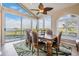 Dining room with high ceilings, a ceiling fan, water views and floor to ceiling windows at 104 Westbrook Ct, Safety Harbor, FL 34695