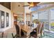 Dining room with high ceilings, a ceiling fan, water views and floor to ceiling windows at 104 Westbrook Ct, Safety Harbor, FL 34695