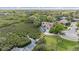 Beautiful home with a screened-in pool and a private dock surrounded by lush greenery at 104 Westbrook Ct, Safety Harbor, FL 34695