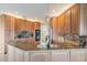 Bright kitchen featuring granite countertops, wooden cabinets, and modern appliances at 104 Westbrook Ct, Safety Harbor, FL 34695