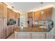 Bright kitchen featuring granite countertops, wooden cabinets, and modern appliances at 104 Westbrook Ct, Safety Harbor, FL 34695