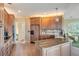 Bright kitchen featuring granite countertops, wooden cabinets, and modern appliances at 104 Westbrook Ct, Safety Harbor, FL 34695