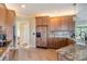 Bright kitchen featuring granite countertops, wooden cabinets, and modern appliances at 104 Westbrook Ct, Safety Harbor, FL 34695