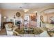 Open living room with fireplace, hardwood floors, and view into kitchen at 104 Westbrook Ct, Safety Harbor, FL 34695