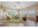 Spacious living room with hardwood floors, large windows, and comfortable seating at 104 Westbrook Ct, Safety Harbor, FL 34695