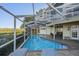 An enclosed pool is great for cooling off on those hot days with views of the yard at 104 Westbrook Ct, Safety Harbor, FL 34695