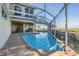 Enclosed pool and patio area offers beautiful views of the water in the backyard at 104 Westbrook Ct, Safety Harbor, FL 34695