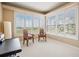 Bright sitting area features large windows, plantation shutters, and two armchairs at 104 Westbrook Ct, Safety Harbor, FL 34695