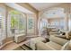 Bright sitting area with hardwood floors, neutral walls, and large windows overlooking the yard at 104 Westbrook Ct, Safety Harbor, FL 34695