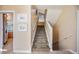 Carpeted stairway with white railings leads to the upper level; kitchen visible at 104 Westbrook Ct, Safety Harbor, FL 34695