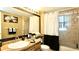 Bright bathroom featuring a wood vanity, a shower with glass doors, and contemporary fixtures at 10440 Laval St, Spring Hill, FL 34608