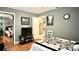 Well lit bedroom with views to the entryway with hardwood flooring and gray colored walls at 10440 Laval St, Spring Hill, FL 34608