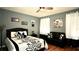 Nicely decorated bedroom with a black and white themed bed and dark hardwood floors at 10440 Laval St, Spring Hill, FL 34608