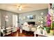 Comfortable bedroom with desk area, hardwood floors, ceiling fan and plenty of natural light at 10440 Laval St, Spring Hill, FL 34608