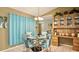 Open-concept dining area featuring a round glass table with matching upholstered chairs at 10440 Laval St, Spring Hill, FL 34608
