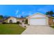 Charming single-Gathering home with lush green lawn, stone accents, and a convenient two-car attached garage at 10440 Laval St, Spring Hill, FL 34608