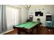 Spacious game room featuring a pool table, arcade games, and a mounted television for entertainment at 10440 Laval St, Spring Hill, FL 34608