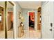 Bright hallway with tiled floor that shows an entryway with mirrors, and access to other rooms at 10440 Laval St, Spring Hill, FL 34608