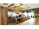 Kitchen featuring wood cabinets, stainless steel appliances and eat in bar with tile floors at 10440 Laval St, Spring Hill, FL 34608