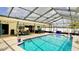 Enclosed pool area with a private pool, lounge area, and bar, perfect for outdoor entertainment and relaxation at 10440 Laval St, Spring Hill, FL 34608