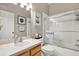 Bright bathroom with a shower-tub combo and a vanity with wooden cabinets at 11190 Windsor Place Cir, Tampa, FL 33626