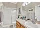 Bright bathroom with a shower-tub combo featuring sliding glass doors at 11190 Windsor Place Cir, Tampa, FL 33626