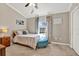 Cozy bedroom with neutral walls, a comfortable bed, and a bright window at 11190 Windsor Place Cir, Tampa, FL 33626