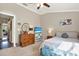 Comfortable bedroom featuring a TV, dresser, and cozy decor at 11190 Windsor Place Cir, Tampa, FL 33626