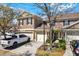 Exterior view of a townhome with attached garages and manicured landscaping at 11190 Windsor Place Cir, Tampa, FL 33626