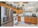 Well-lit kitchen with stainless steel appliances, wood cabinets, and tile flooring at 11190 Windsor Place Cir, Tampa, FL 33626