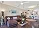 Cozy living room featuring dark hardwood floors, plush leather seating, and stylish décor at 11190 Windsor Place Cir, Tampa, FL 33626