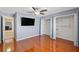 Spacious bedroom featuring wood floors, a ceiling fan, closets, and blue walls at 11207 Allwood St, Spring Hill, FL 34609