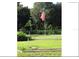 Backyard featuring an American flag, green grass, and a few trees in the background at 11326 Brightridge Dr, Seffner, FL 33584