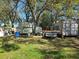 Large, shady backyard with trailers, containers, and project materials at 11326 Brightridge Dr, Seffner, FL 33584