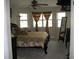 Bright bedroom featuring detailed bed frame, multiple windows, and full length mirror at 11326 Brightridge Dr, Seffner, FL 33584