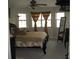 Bright bedroom featuring detailed bed frame, multiple windows, and full length mirror at 11326 Brightridge Dr, Seffner, FL 33584