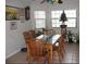 Inviting dining room with a large table, six chairs, two windows, and tile flooring at 11326 Brightridge Dr, Seffner, FL 33584