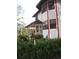 Lovely home with a red trim, inviting front porch, and lush greenery, highlighting the property's curb appeal at 11326 Brightridge Dr, Seffner, FL 33584