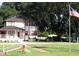 Charming two-story home with a red trimmed exterior, a front porch and American flag on a spacious lot at 11326 Brightridge Dr, Seffner, FL 33584