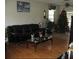 Living room featuring a black sofa, hardwood floors, a Christmas tree, and a ceiling fan at 11326 Brightridge Dr, Seffner, FL 33584